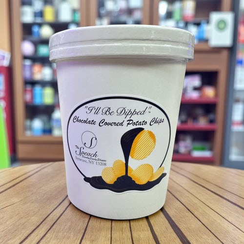 8 ounce container of chocolate covered potato chips on wooden counter in store