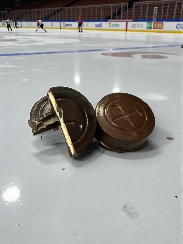 Top Shelf Hockey Puck - chocolate hockey puck filled with white ganache on an ice rink