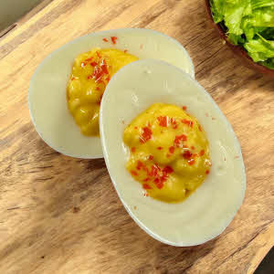 White Chocolate Deviled Eggs on counter top with lettuce
