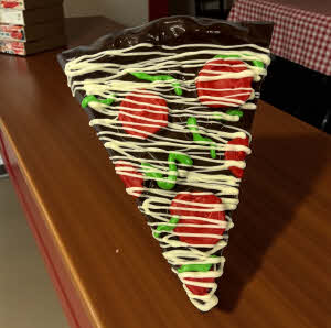 Dark chocolate potato chip pizza slice on countertop in pizzeria