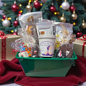Holiday candy gift basket on blanket in front of decorated tree