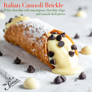 Italian Cannoli Brickle label - cannoli on parchment paper with chocolate chips and drops of white chocolate