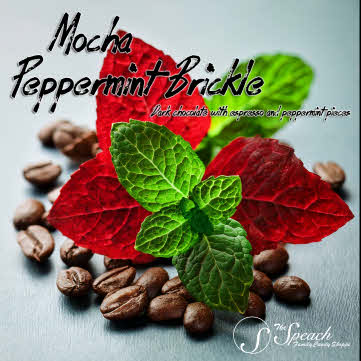 Mocha Peppermint Brickle label with fresh green mint, red mint leaves and coffee beans on a cool blue countertop